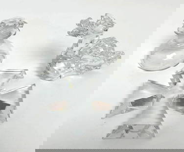 THREE BACCARAT CRYSTAL FIGURES: This set features three distinct Baccarat crystal figures, each showcasing the renowned craftsmanship and clarity of Baccarat crystal. The collection includes a small, clear glass perfume bottle with