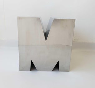A CHROME-METAL “LETTER M" SIDE TABLE