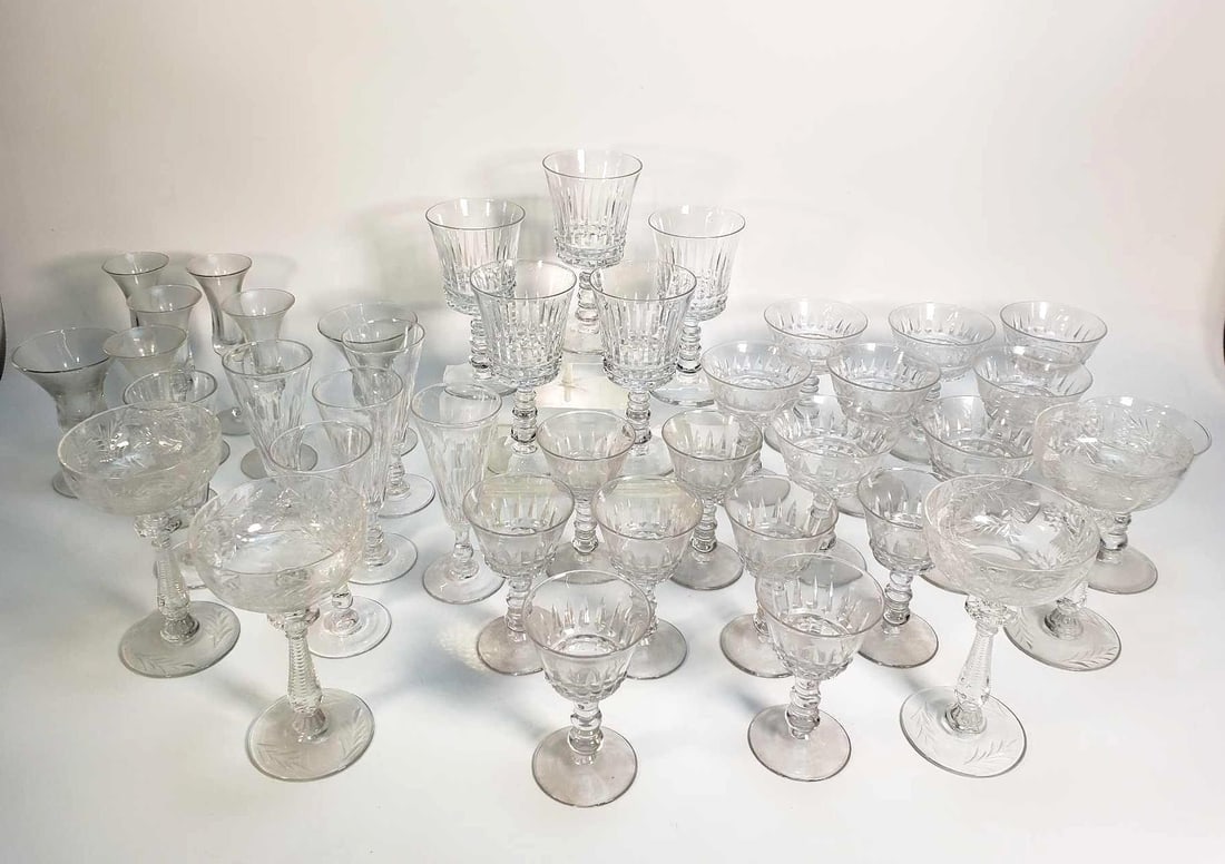 VALUE LOT: COLLECTION OF VINTAGE CRYSTAL STEMWARE: A collection of vintage crystal stemware, featuring various shapes and sizes of glasses, many with etched or cut patterns on the bowls and stems. Dimensions: 6.25"H TALLEST Artist or Maker: Unknow