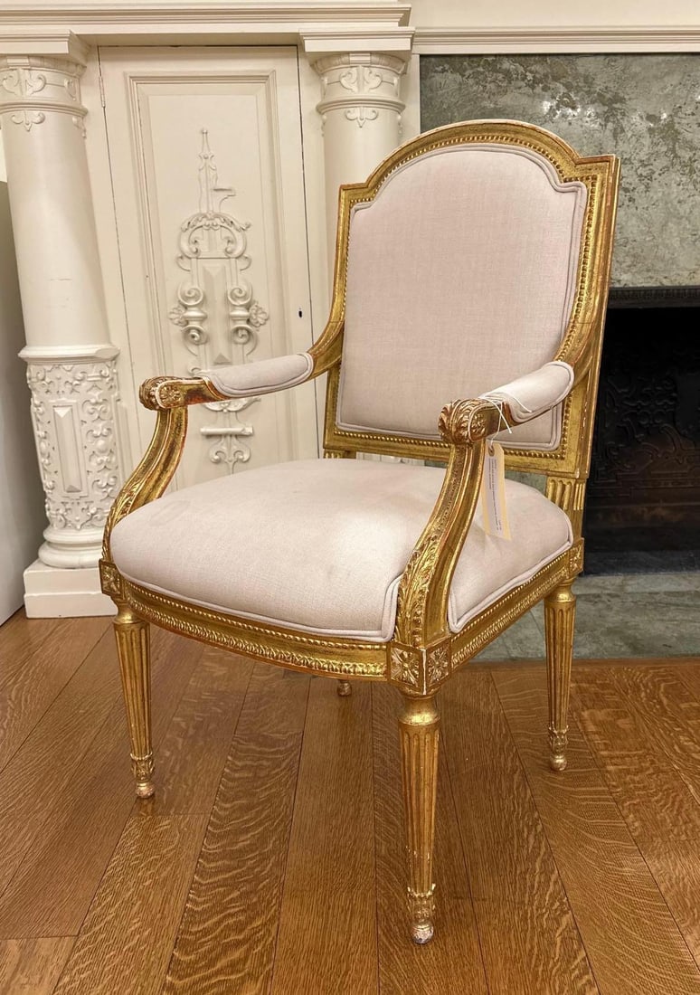 LOUIS XVI STYLE GILT-WOOD FAUTEUIL CHAIR: A French Louis XVI Style Gilt-Wood Armchair from the Moschino NYC showroom. Dimensions: 28 x 24 x 36" High Artist or Maker: Unknown Notes: Although care is taken to photograph and describe the item