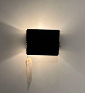 MID-CENTURY MODERN CHARLOTTE PERRIAND CP1 WALL SCONCE - BLACK SHADE (2 OF 5): A Charlotte Perriand CP1 wall sconce featuring a square black adjustable shade and a bracket that affixes it to the wall, emitting light both upwards and downwards. From the Moschino NYC showroom Di
