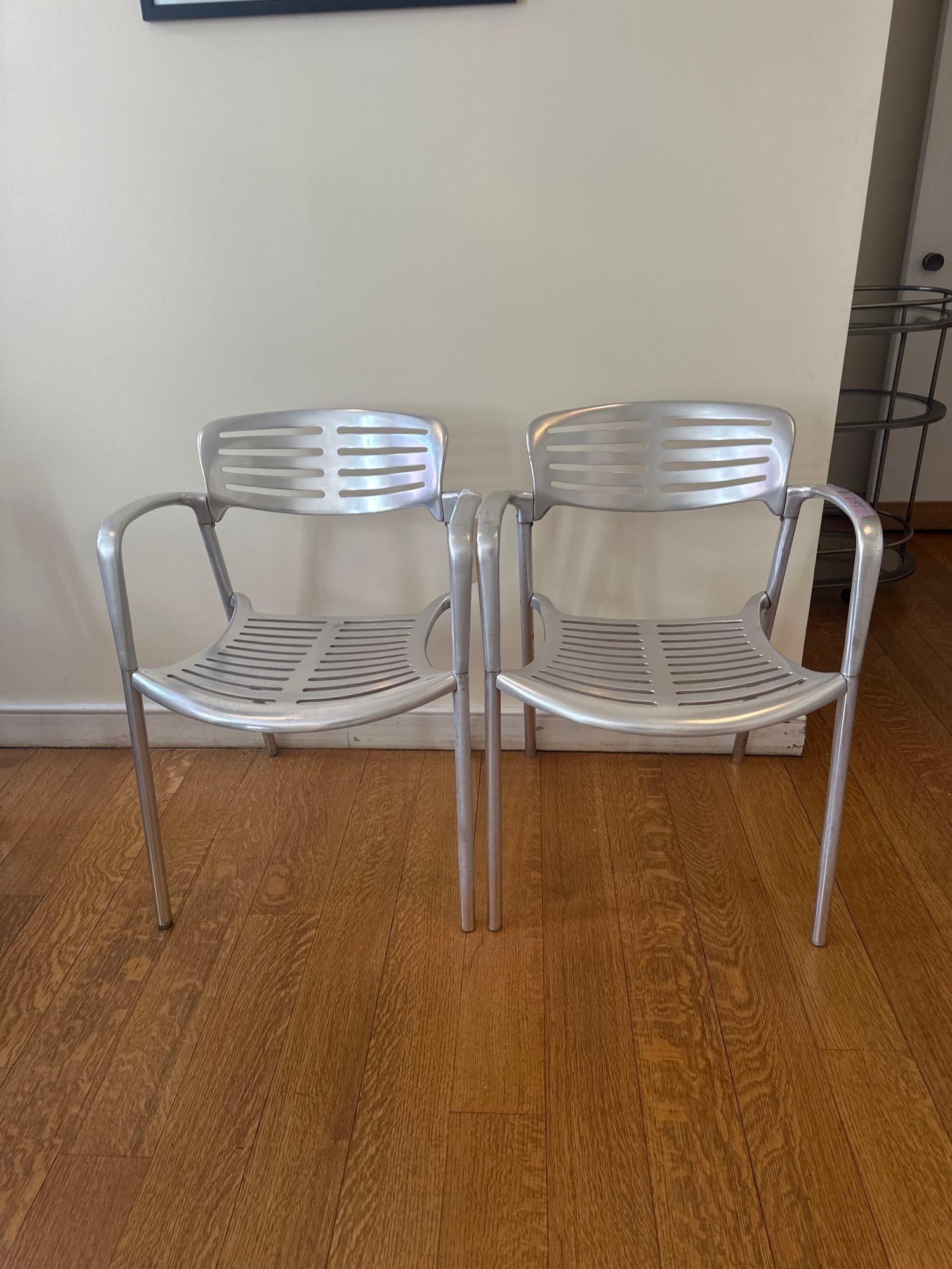 JORGE PENSI TOLEDO CHAIR - ALUMINUM: A pair of Jorge Pensi Toledo chairs, constructed from aluminum with a slatted seat and back. From the Moschino NYC showroom. Dimensions: W26 D29 H31. Artist or Maker: Jorge Pensi This item is part