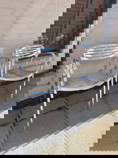 JORGE PENSI TOLEDO CHAIR - ALUMINUM(LOT 7 OF 17): A pair of Jorge Pensi Toledo chairs, constructed from aluminum with a slatted seat and back. This pair was used outdoors, so finish is dulled and aluminum is discolored, see photos. From the Moschino