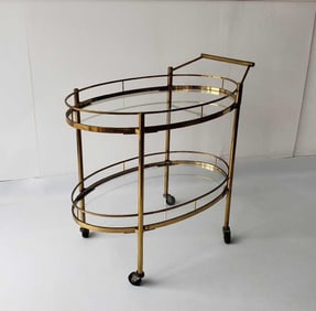 MID-CENTURY MAXWELL-PHILLIPS STYLE TWO-TIER OVAL BRASS AND GLASS BAR CART
