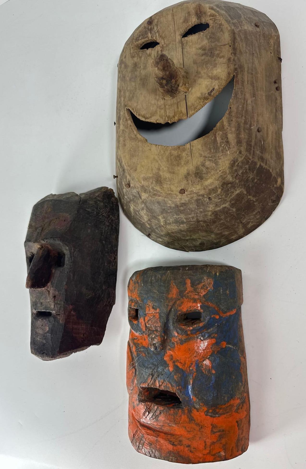 A TRIO OF RARE ANTIQUE POLYCHROME AND NAIL-DETAIL WOODEN MASKS (1 of 13)
