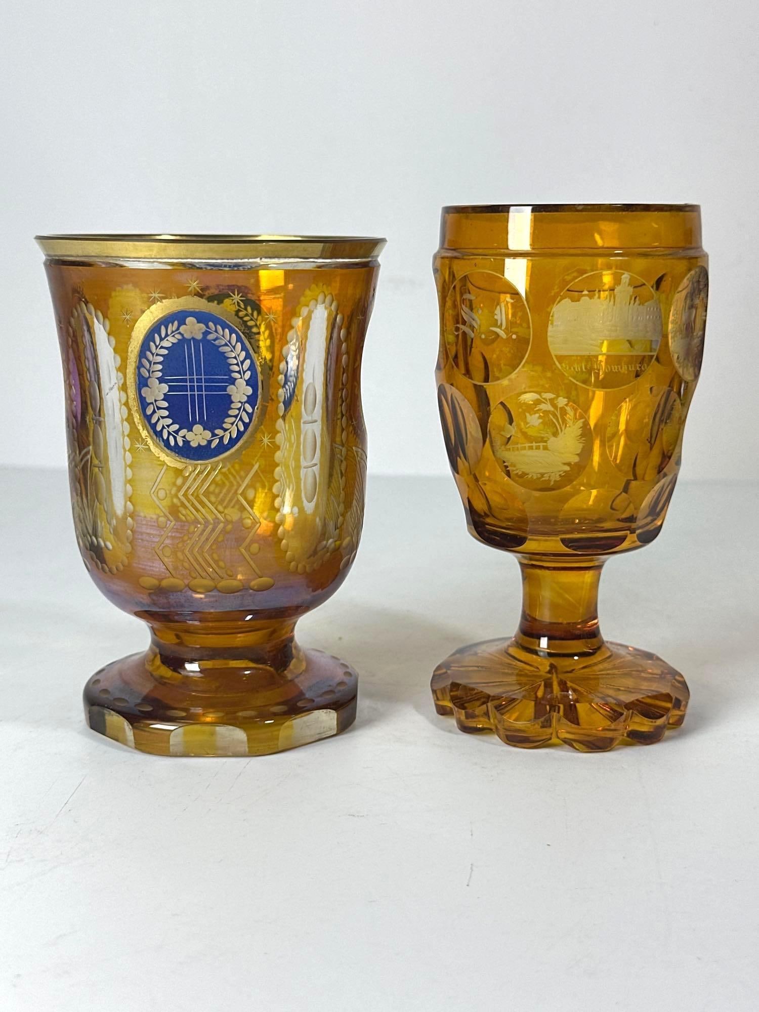 PAIR OF ANTIQUE BOHEMIAN AMBER BEDERMEIER CUT/ETCHED GOBLETS: Crafted from rich amber glass, they feature sophisticated cut and etched designs. Their vibrant color and meticulous craftsmanship make them highly sought-after examples of 19th-century Czech glass ar