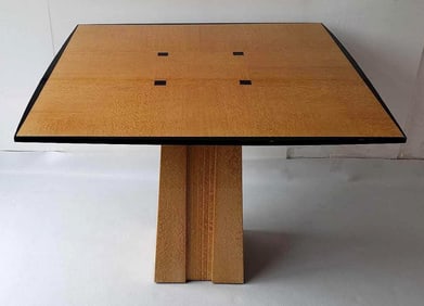 POSTMODERN QUILTED MAPLE DINING TABLE WITH PEDESTAL BASE AND EBONIZED ACCENTS (lot 1 of 2)