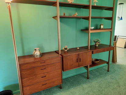 GEORGE NELSON FOR HERMAN MILLER OMNI THREE BAY SHELVING UNIT: A vintage mid-century modern Omni shelving unit by George Nelson for Herman Miller, featuring modular wooden shelves and cabinets supported by a metal pole system. (4) upright posts (1) 4 drawer unit
