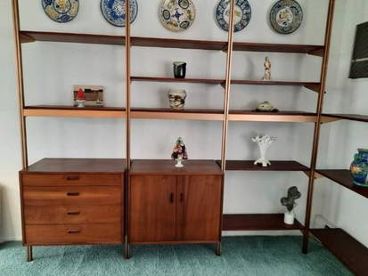 GEORGE NELSON FOR HERMAN MILLER OMNI FOUR BAY SHELVING UNIT: A vintage mid-century modern Omni shelving unit by George Nelson for Herman Miller, featuring modular wooden shelves and cabinets supported by a metal pole system. 5) upright posts (1) 4 drawer unit (