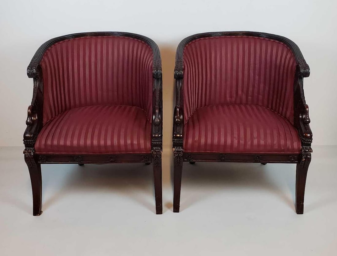 PAIR OF ANTIQUE FRENCH SWAN FIGURAL MAHOGANY TUB CHAIRS: A pair of antique French swan figural mahogany tub chairs, featuring carved swan details on the arms, and striped maroon upholstery. Dimensions: 33.5"h x 27.5"w x 26"d Artist or Maker: Unknown, Made i