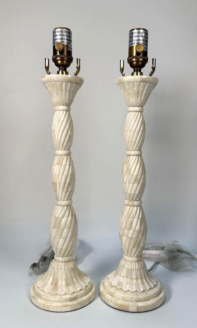 PAIR OF INDIAN TABLE LAMPS: A pair of late 20th century table lamp bases, likely crafted from bone with visible striations, featuring a twisted, fluted column. Dimensions: 19" Tall Artist or Maker: Unknown Notes: Although care i