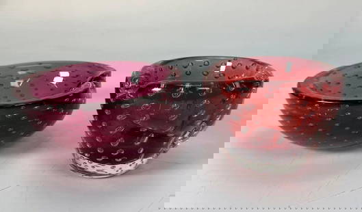 VINTAGE MURANO ART GLASS BULLICANTE CONTROLLED BUBBLE BOWL & ASHTRAY: A vintage Murano Art Glass "Bullicante" controlled bubble bowl and ashtray, each crafted from translucent, garnet ruby colored glass, one being a heart-shaped dish and the other a deeper, rounded vess
