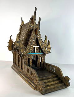 VINTAGE THAI SPIRIT HOUSE TEMPLE MODEL / HOME TEMPLE: An ornate, multi-tiered intricate wooden model of a Thai Buddhist temple with intricate carvings, a tiered roof with pointed finials, and a front platform with a railing and steps, all in a distressed