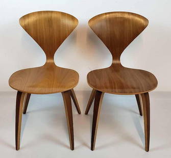 PAIR OF MID CENTURY NORMAN CHERNER WALNUT SIDE CHAIRS: A pair of light-colored wooden side chairs, featuring a molded plywood seat and backrest. Dimensions: 31.25"H x 17"W x 21D Artist or Maker: Norman Cherner Provenance: From a New York Collector N