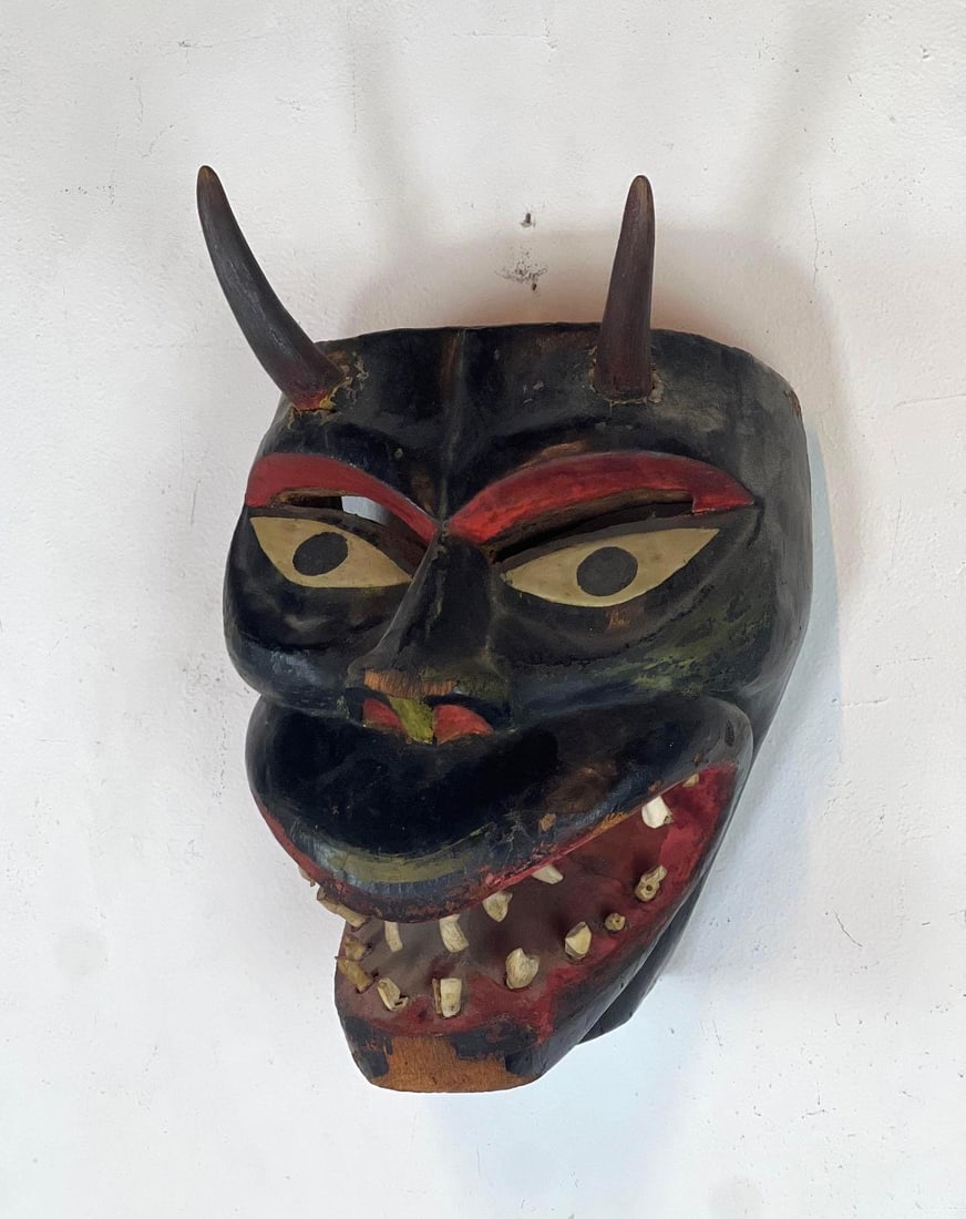 WOODEN MASK WITH HORNS AND TEETH: Multicolor carved wooden devil-like mask with horns & teeth design Dimensions: 13.5" Tall x 8" x 6.5" Artist or Maker: Unknown Provenance: From the estate of a nonagenarian New York pr