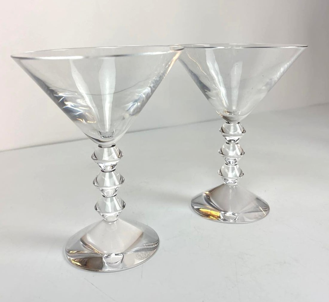 PAIR OF BACCARAT CRYSTAL MARTINI GLASSES: A pair of Baccarat 'Vega' crystal martini glasses. Dimensions: 6” High Artist or Maker: Baccarat Provenance: The Living Estate of Joseph Rodano Notes: Although care is taken t