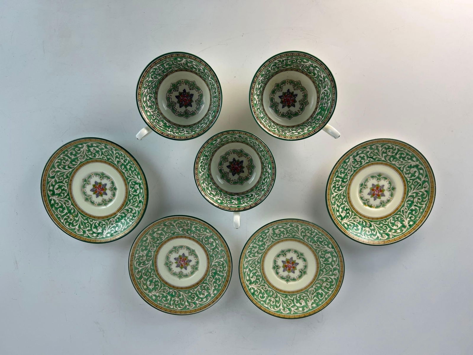 VALUE LOT WEDGWOOD BONE CHINA TEACUP AND SAUCER SET: A Wedgwood bone china teacup and saucer set that includes three teacups and four saucers. Dimensions: 3 TEACUPS 2.25" T X 4"DIA 4 SAUCERS 4.75" DIA Artist or Maker: Wedgwood Provenance: