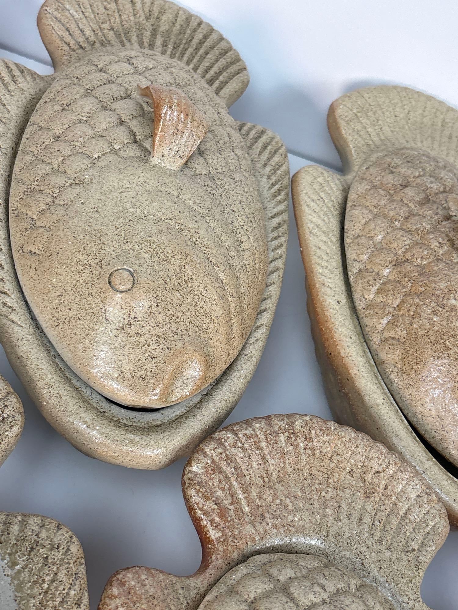 VALUE LOT SET OF SEVEN STONE OR CLAY FISH-SHAPED COVERED DISHES (1 of 7)