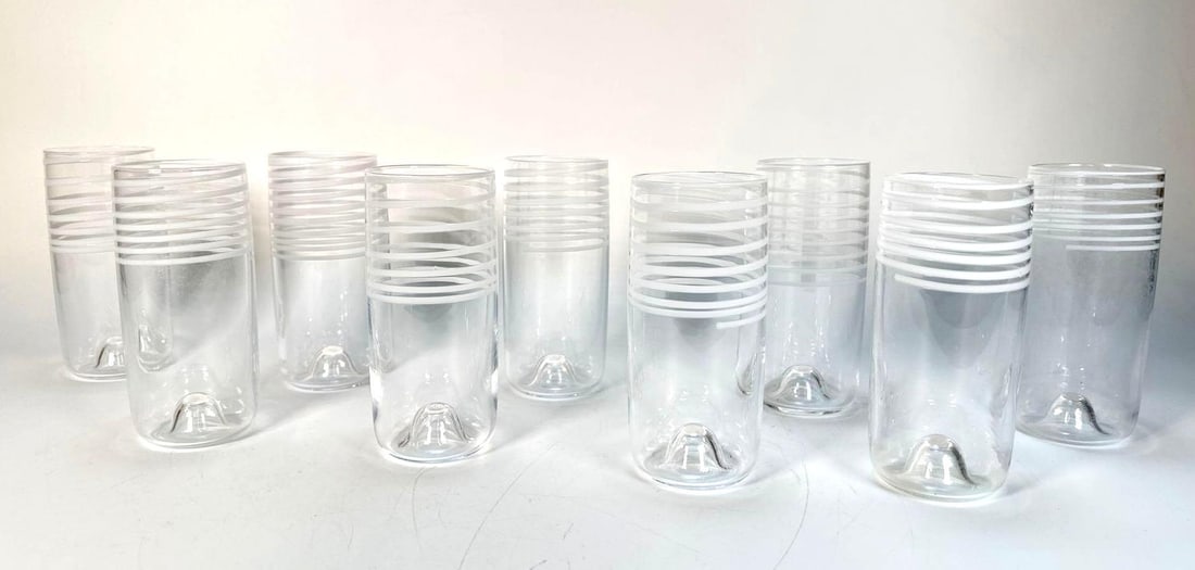 9 MURANO STYLE SPIRAL DRINKING GLASSES: Carlo Moretti Style Clear & White Striped Tumblers Dimensions: 6"T x 2.5"DIA Maker: Unknown Provenance: A prominent NYC retail family Notes: Although care is taken to photograph and de