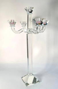 LARGE CRYSTAL CANDELABRA IN THE STYLE OF BACCARAT: A large Baccarat-style crystal candelabra which features a tall, clear faceted stem rising from a hexagonal base, branching out to hold four candle cups.  Dimensions: 23.5&#34;T x 13.25&#34;W  Artist