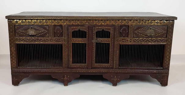 RARE VINTAGE MIDDLE EASTERN STYLE CARVED WOOD / BRASS MOUNTED LOW CABINET: A rare vintage Middle Eastern style carved wood and brass-mounted low cabinet. The cabinet features a dark wood construction, adorned with brass accents and intricate carving. Dimensions: 23.5"h x 53