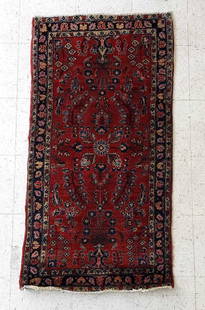 ANTIQUE PERSIAN HAND-KNOTTED RUNNER RUG WITH DEEP RED FIELD: An antique Persian hand-knotted runner rug, featuring a deep red field and an intricate pattern of stylized floral motifs and medallions in shades of blue, pink, and gold.  Dimensions: 4&#39;10&#34; x
