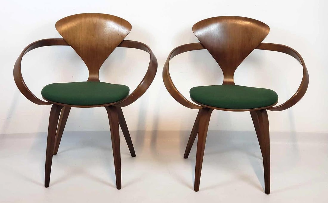 PAIR OF MID CENTURY NORMAN CHERNER FOR PLYCRAFT ARM CHAIRS: *This is a pair of wooden armchairs, each featuring a molded plywood seat and backrest, an open C-shaped armrest integrated into the back, and four splayed wooden legs, with a round green cushion on t