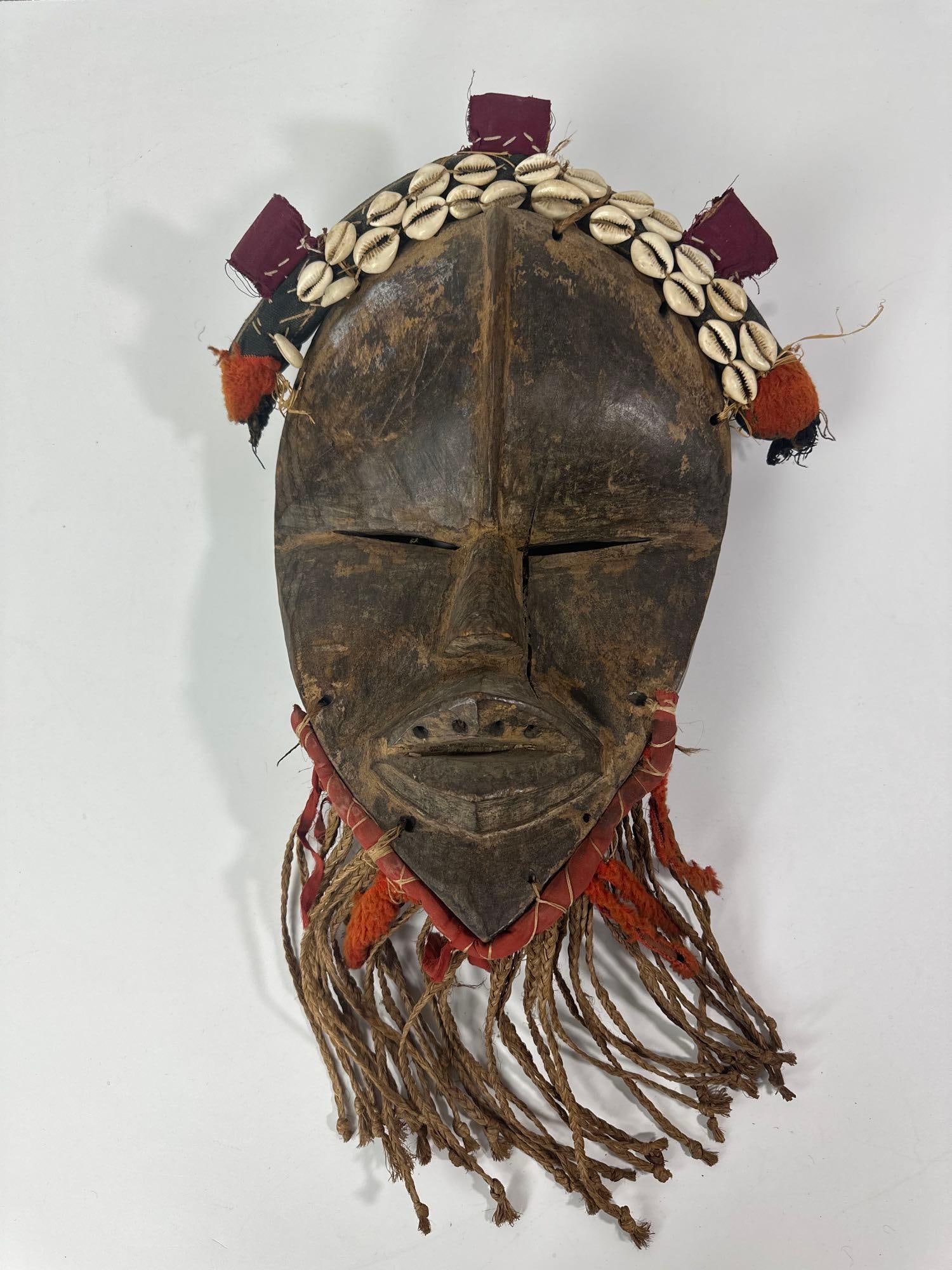 AUTHENTIC DAN MASK - TRADITIONAL AFRICAN ART FROM THE IVORY COAST: *A authentic Dan mask, a prime example of traditional African art originating from the Ivory Coast, embodying cultural significance and masterful craftsmanship. Dimensions: Wood Mask: 15.5 H x 11" W x