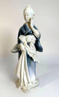 PORCELAIN GEISHA STATUE WITH BLUE GOWN: *Porcelain Statue of a woman in a blue gown  Dimensions: 10.5IN TALL X 4.5IN WIDE Artist/Maker: unknown  Provenance: From the estate of an nonagenarian lifelong New York private collector of Asian art