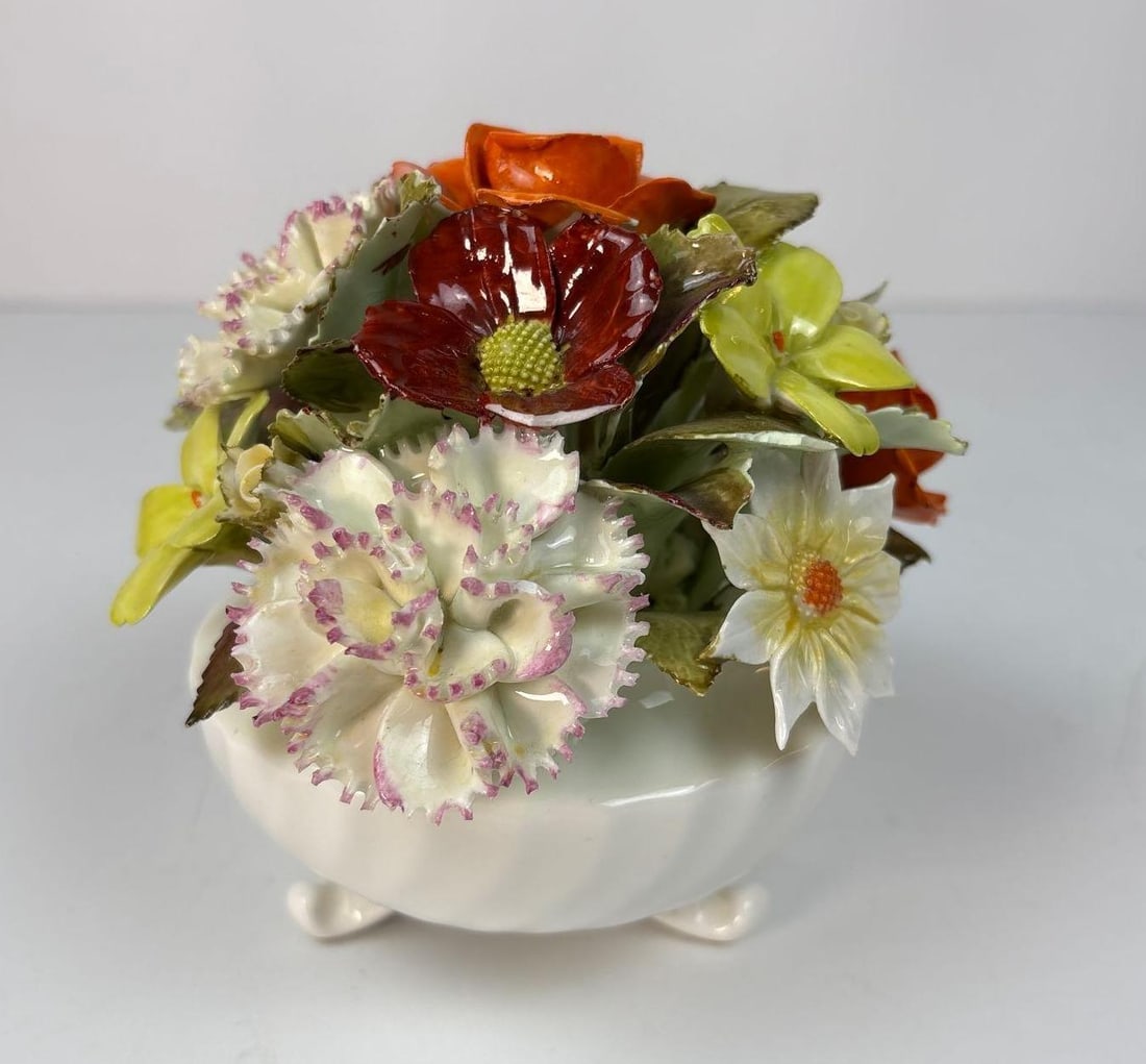 VALUE LOT: CAPODIMONTE PORCELAIN BOUQUET: A Capodimonte porcelain bouquet, arranged in a white, footed planter. Dimensions: 5" Tall x 5" Dia Artist or Maker: Capodimonte Provenance: The Living Estate of Joseph Rodano Notes: Al