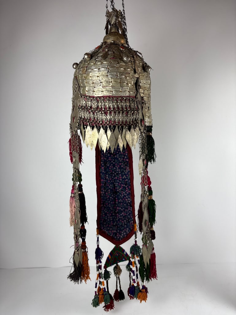 TURKISH CEREMONIAL WEDDING HEADDRESS: An elaborate ceremonial headdress made of metallic elements, chains, and colorful tassels. Statue stand not included. Dimensions: 32.5"L x 8"W Artist or Maker: Unknown Provenance: From a New York Coll