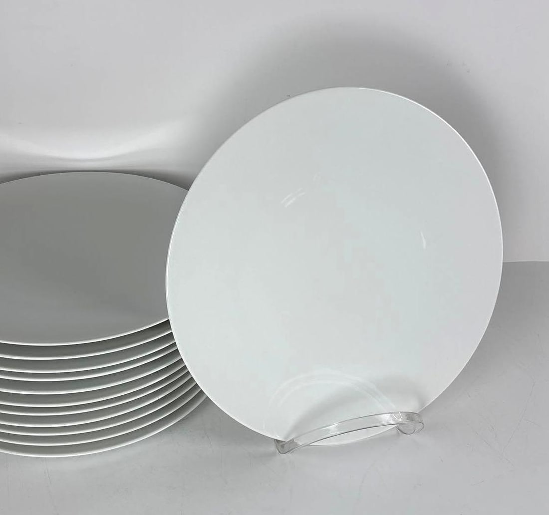 12 ROSENTHAL STUDIO-LINE , GROPIUS GERMANY CHARGERS: A set of 12 white Gropius charger plates. Dimensions: 13" Diameter Maker: Rosenthal Notes: Although care is taken to photograph and describe the item, absence of a condition report does not imply pe