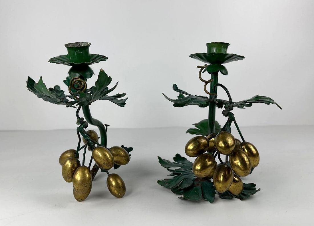 PAIR OF VINTAGE TOLEWARE CANDLESTICKS WITH GRAPEVINE MOTIF: A pair of vintage toleware candlesticks with a grapevine motif. Dimensions: 8.25"T x 8.5"W Artist or Maker: Unknown Provenance: From a New York Collector. Notes: Although care is taken to pho