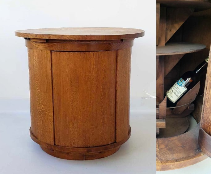 1940's FRENCH OAK BAR TABLE WITH CONCEALED LIQUOR STORAGE IN BASE: *A round table with secret storage, including silde-out class rests. Dimensions: 28.5"T x 30"DIA Maker: Unknown Provenance: A New York Designer Notes: Although care is tak