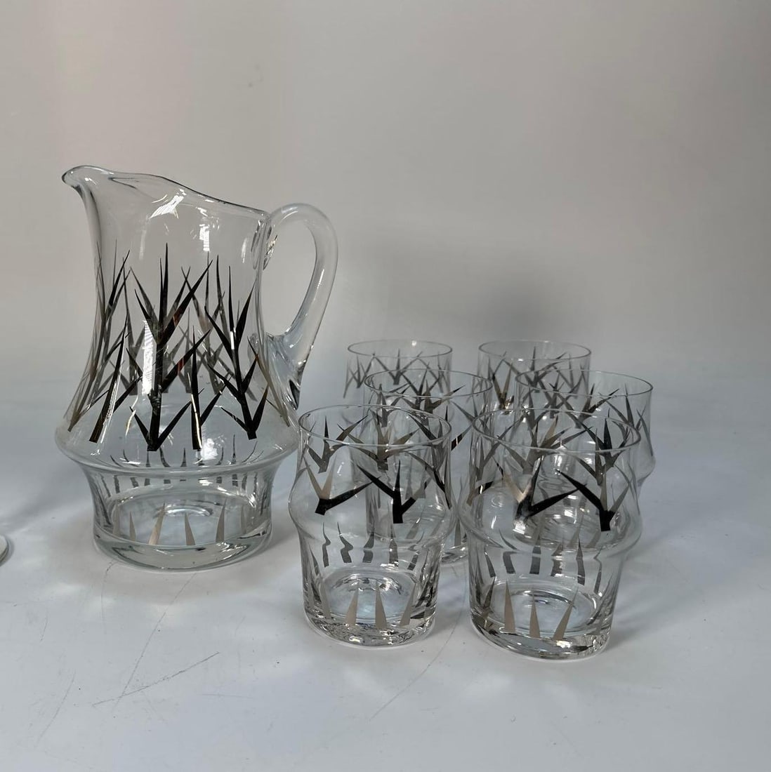 VALUE LOT: MID-CENTURY GLASSWARE PITCHER AND TUMBLERS: *Pitcher with matching glasses. Provenance: From a prominent NYC fashion and retail family.