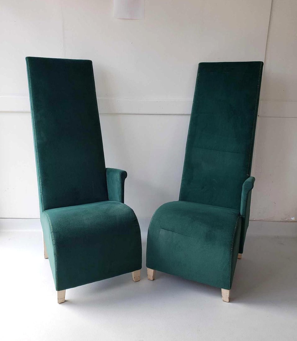 PAIR OF PHILIPPE STARCK MISS PARAMOUNT CHAIRS: *A pair of tall, upholstered chairs with a single armrest on the left side, covered in dark green fabric, and supported by four light-colored wooden legs. From the Paramount Hotel, NYC. Dimensions: 5