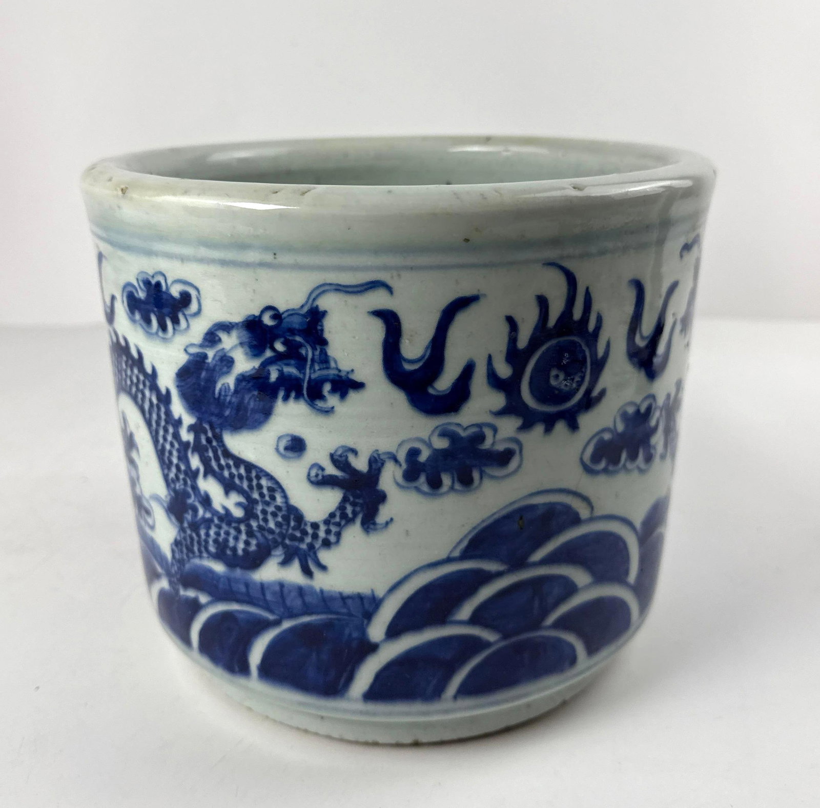 CHINESE BLUE AND WHITE DRAGON CENSER: A Chinese blue and white porcelain censer decorated with a dragon motif. A censer is a traditional vessel for burning incense. Dimensions: 7.5” x 9” diameter Artist or Maker: Unknown Prove