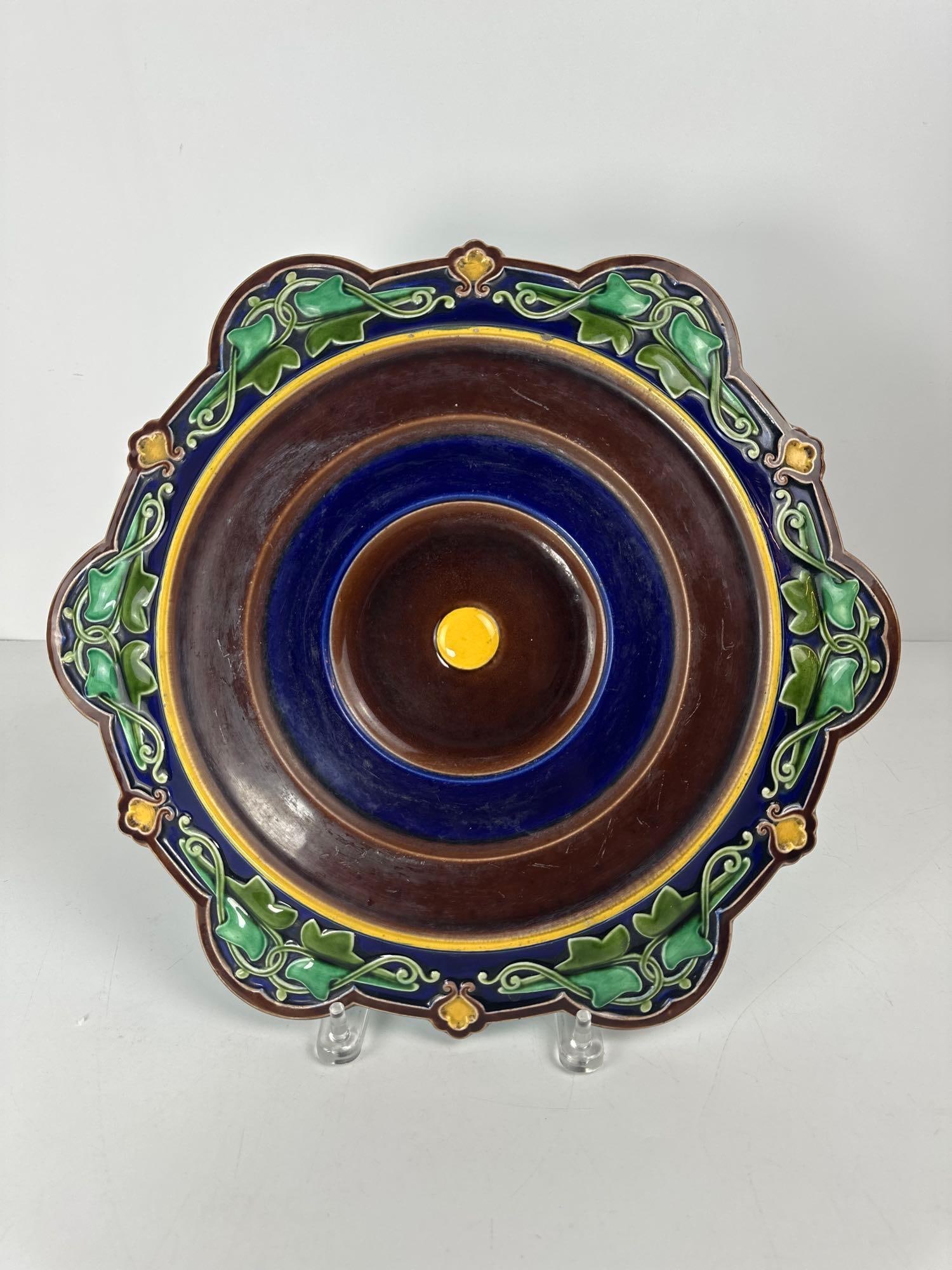 MAJOLICA SARREGUEMINES TRIVET/ PLANT STAND: Ornate Art Nouveau Ceramic Trivet with Raised Leaf & Floral Design Dimensions: 15.25"DIA Maker: Marked Majolica Sarreguemines Provenance: A New York Collector Notes: Although care is taken to photo