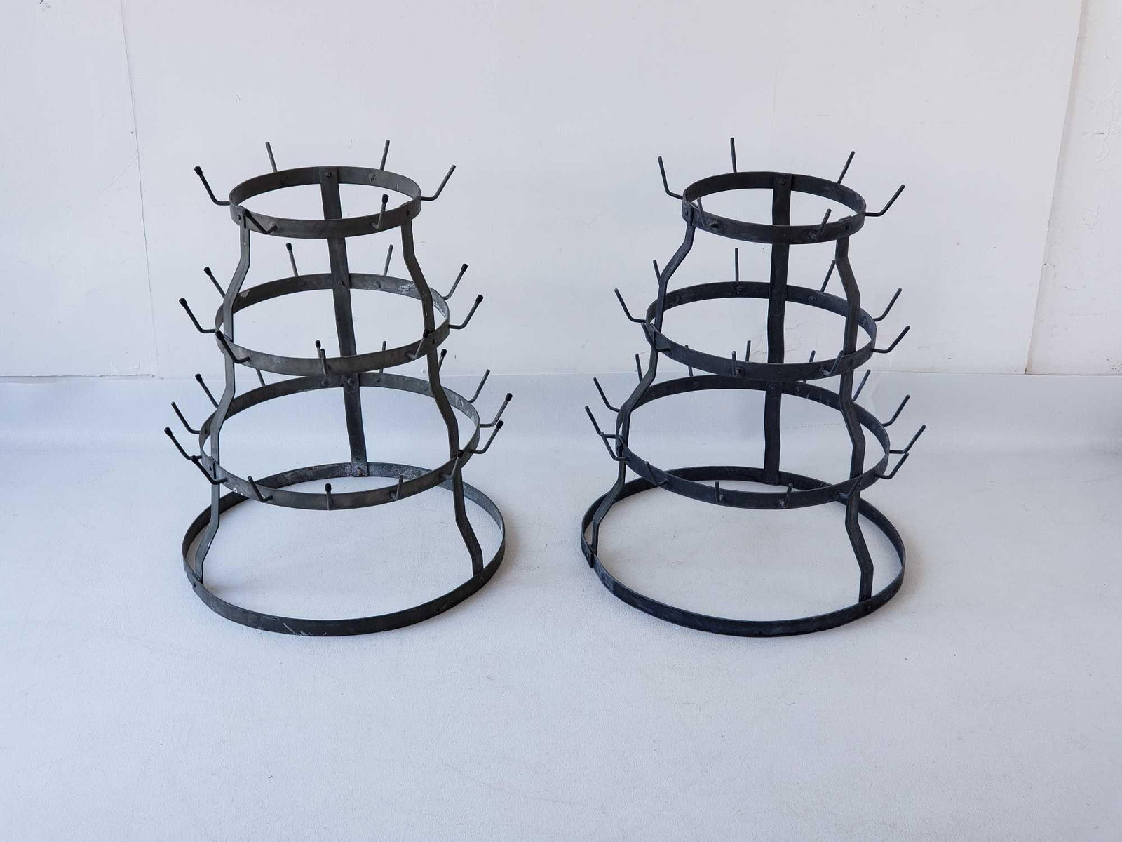 TWO VINTAGE STEEL CHAMPAGNE/WINE BOTTLE DRYING RACKS, FRANCE: A pair of racks used to dry bottles Dimensions: 22"h x 19"dia Maker: Unknown Provenance: A New York Collector Notes: Although care is taken to photograph and describ