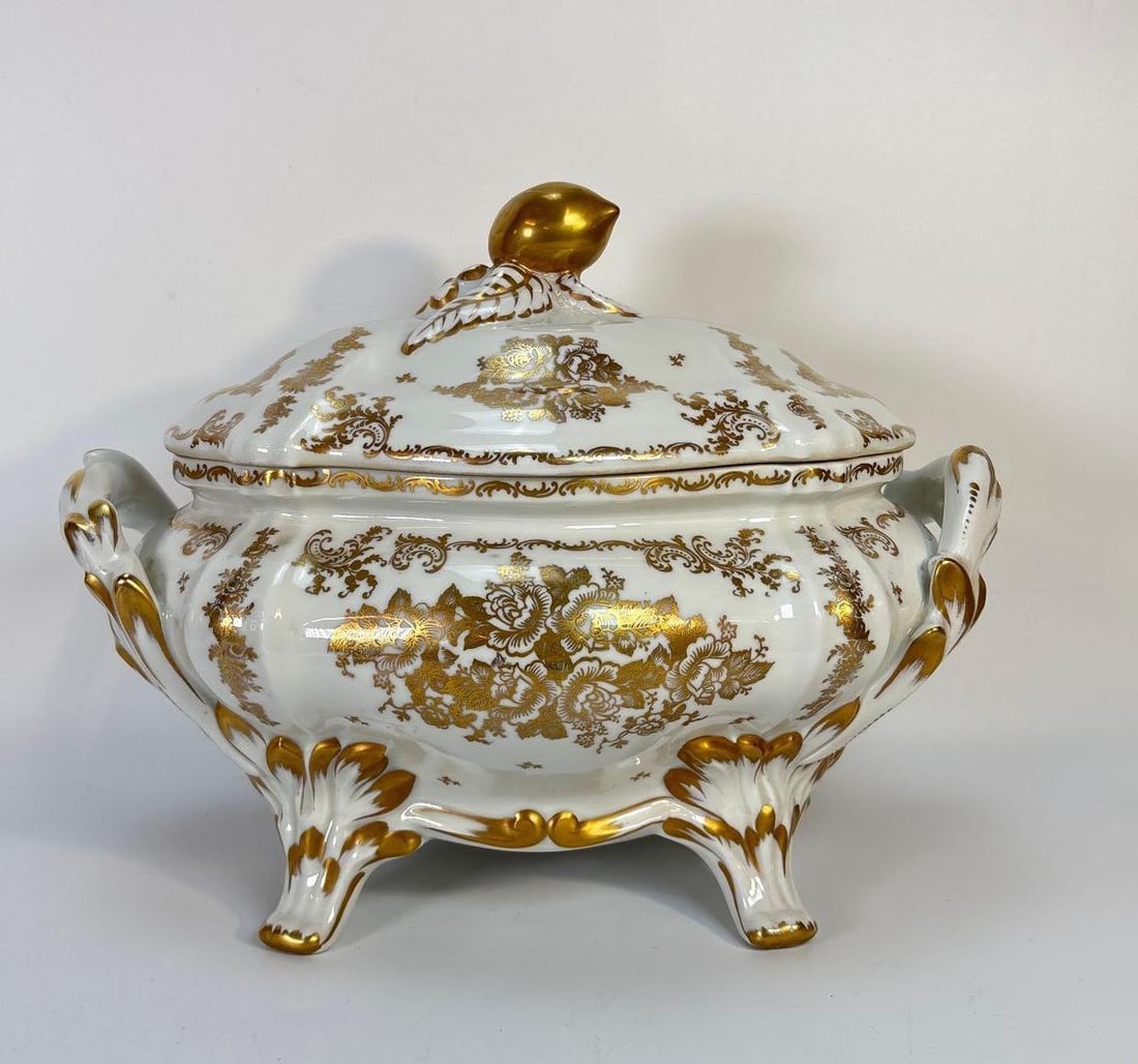 ANTIQUE LIMOGES TUREEN, GILT PORCELAIN WITH FLORAL PATTERN: An antique, oval-shaped Limoges porcelain tureen, featuring a detailed gilt floral pattern, two handles, and four feet. Dimensions: 10.5" x 14" x 9" Artist or Maker: Limoges Provenance: Fr