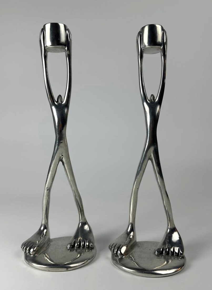 PAIR OF CAROL BOYES CANDLESTICKS: A pair of figural candlesticks. Stamped C. Boyes, S. Africa 2004 Dimensions: 11” Tall Artist/Maker: Carol Boyes Notes: Although care is taken to photograph and describe the item, absence of a