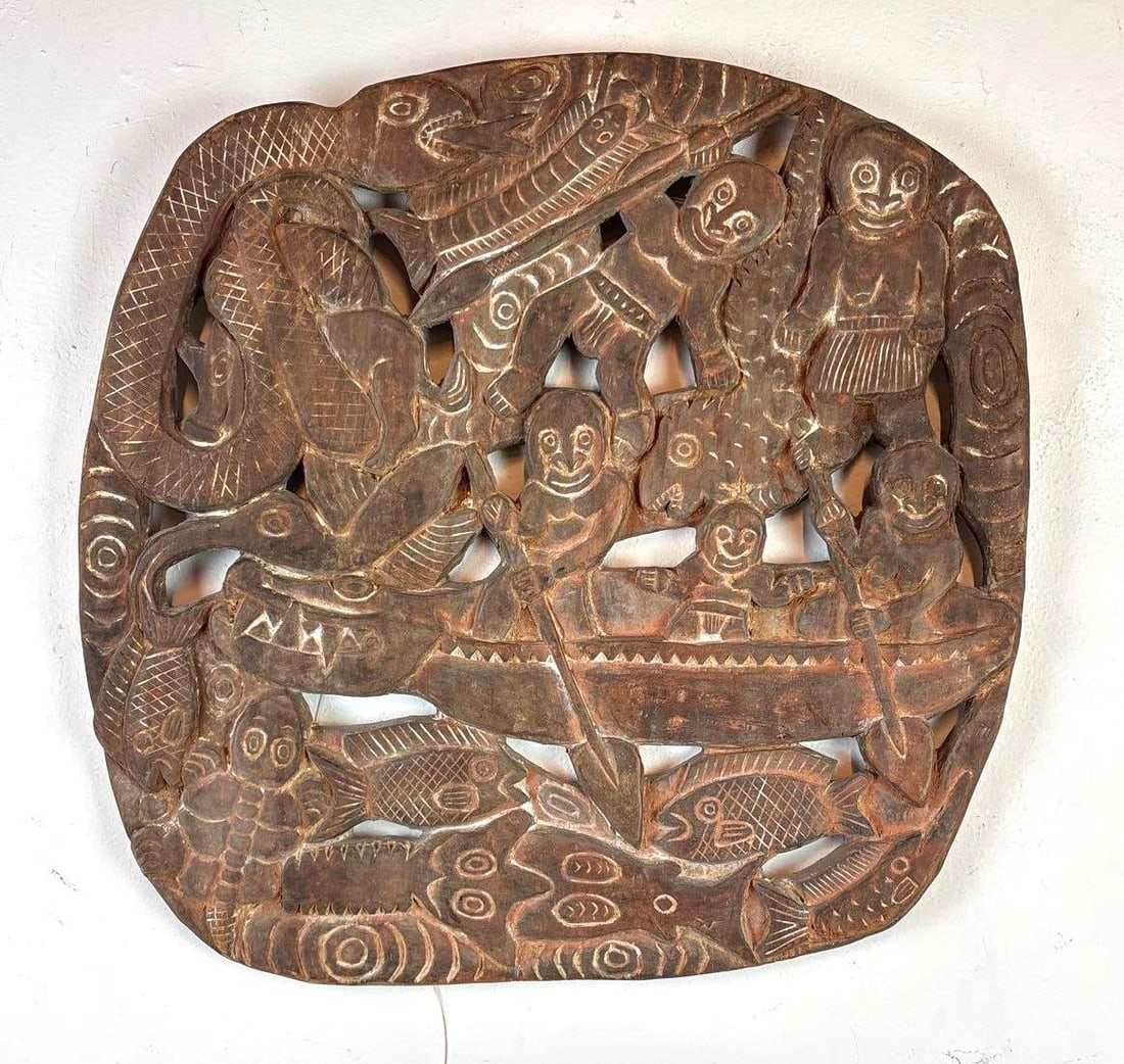 HAND CARVED WOODEN PAPUA NEW GUINEA STORYBOARD: A square-shaped, hand-carved wooden plaque depicting a rowing scene with human figures, animals, and fish. Dimensions: 19"L x 19"W Artist or Maker: Unknown Provenance: From a New York Collector Not