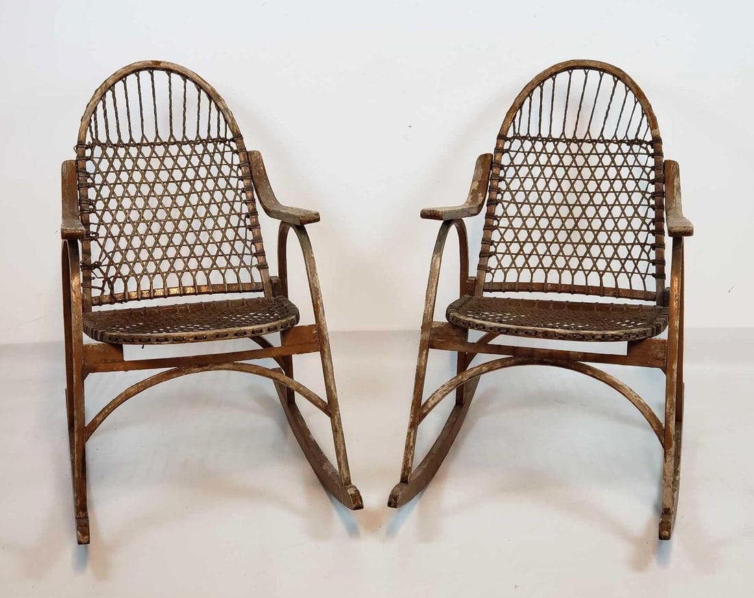 PAIR OF VINTAGE VERMONT TUBBS "SNOWSHOE" ROCKING CHAIRS: A pair of classic rocking chairs with rawhide lacing stamped Vermont Tubbs Dimensions: 33"h x 21.5"w x 32"d Maker: Vermont Tubbs Provenance: A New York Collector Notes: Although care is taken to ph