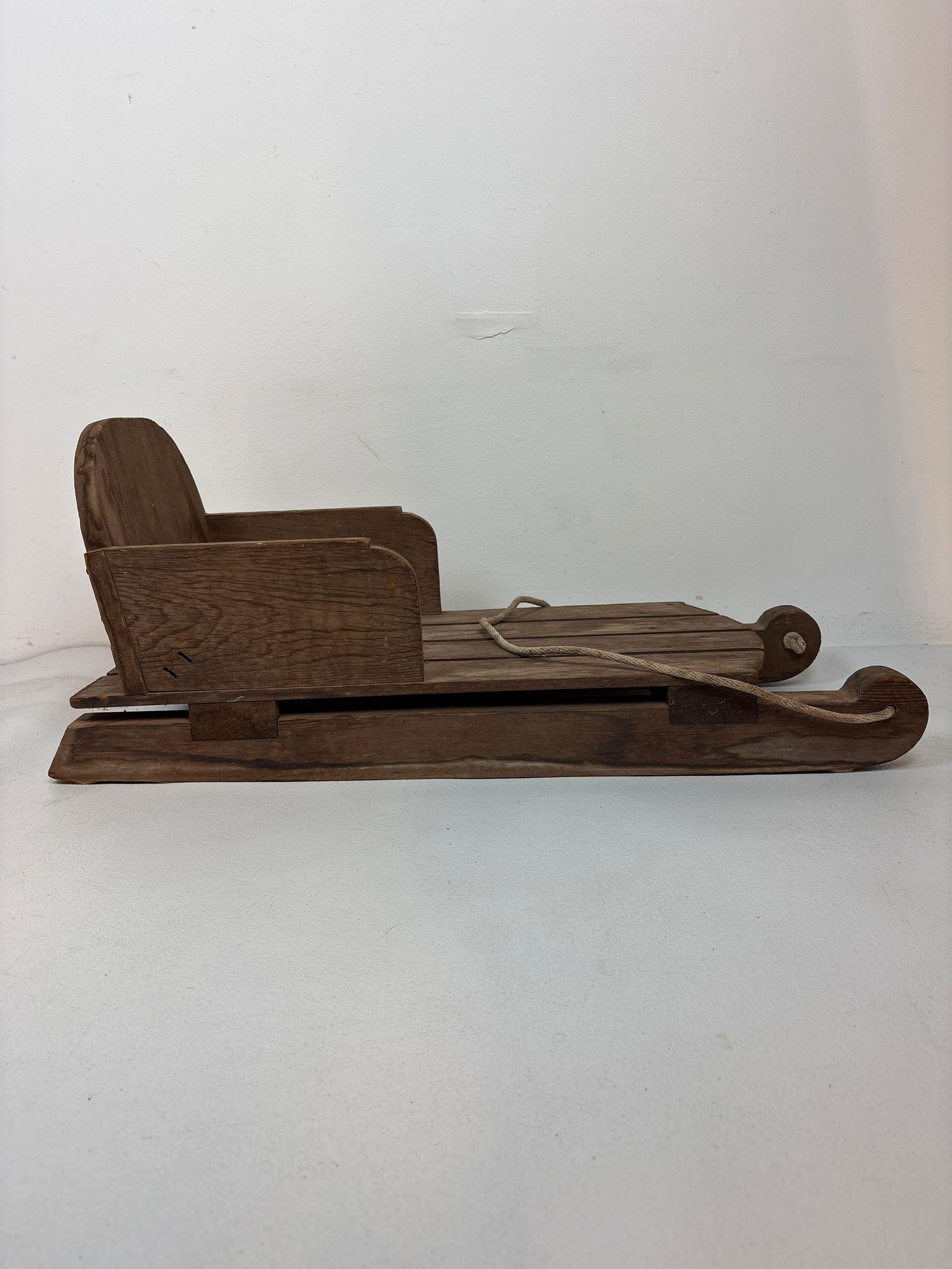 VINTAGE RUSTIC WOODEN CHILD'S SLED: *A vintage rustic wooden child's sled crafted from weathered wood with a rope handle. Dimensions: 13" Tall x 13" x 31" Artist or Maker: Unknown Provenance: From a New York Collector