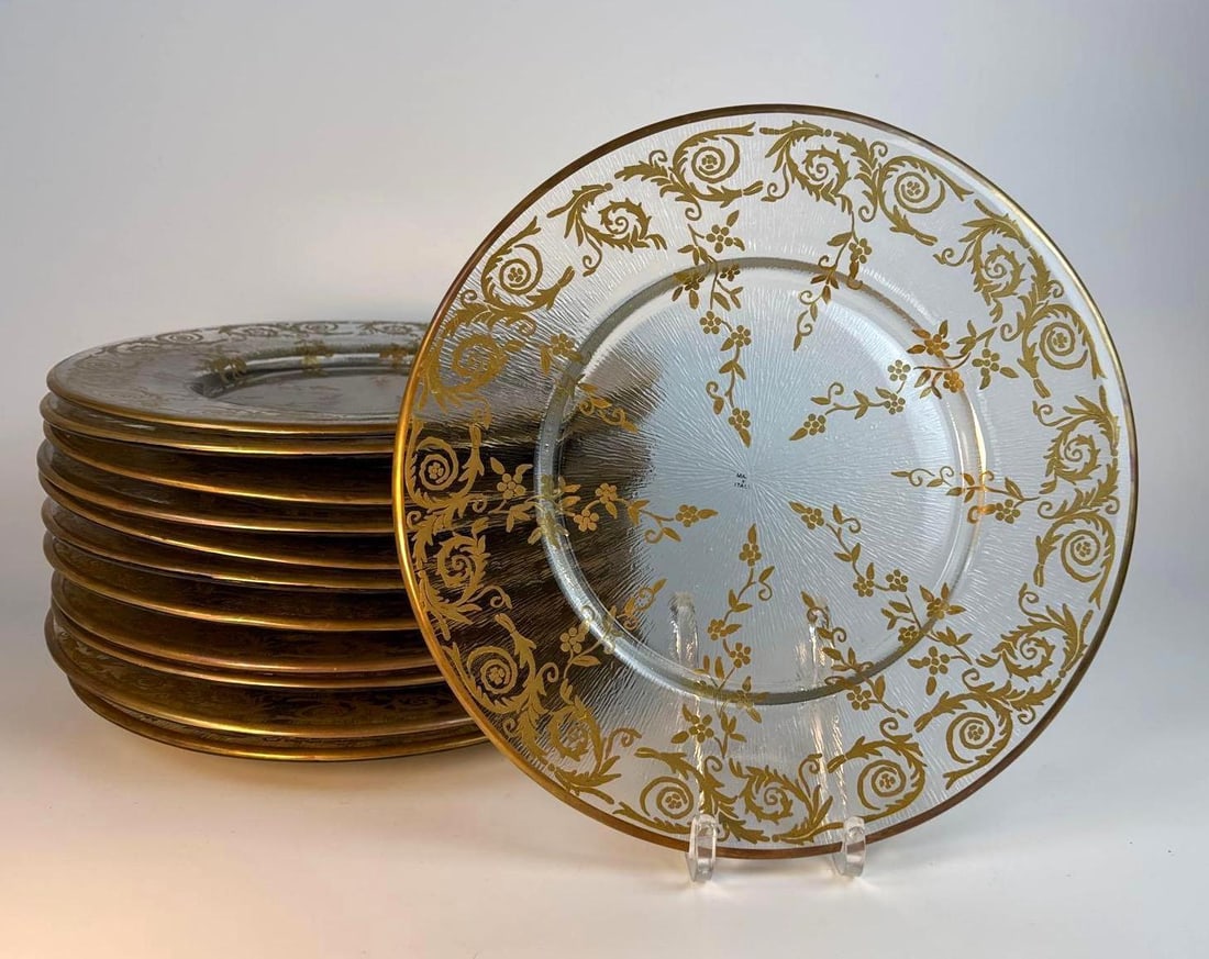GLASS PLATES WITH HAND PAINTED GILT FLORENTINE PATTERN, ITALY: Set of 12 Florentine style Art deco style textured glass charger plates with gold scrollwork design Dimensions: 12” dia Maker: Florentine Provenance: A New York Collector Notes: Although care