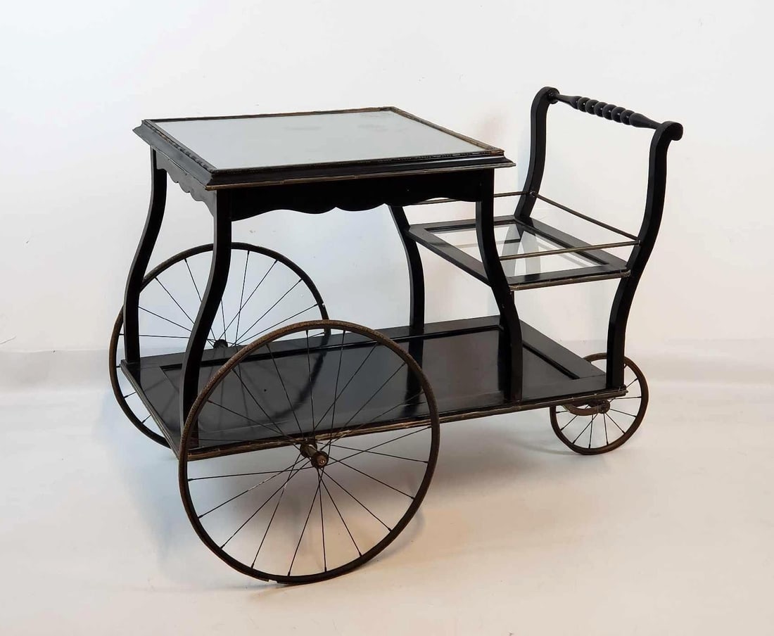ADOLF LOOS STYLE VIENNESE ART NOUVEAU BAR CART: *A two-tiered, mobile serving cart made of dark-toned wood with metal hardware, including a handle, gallery railings, and a stretcher, all on three spoke wheels. Dimensions: 30"T x 36"W x 23"D Artis