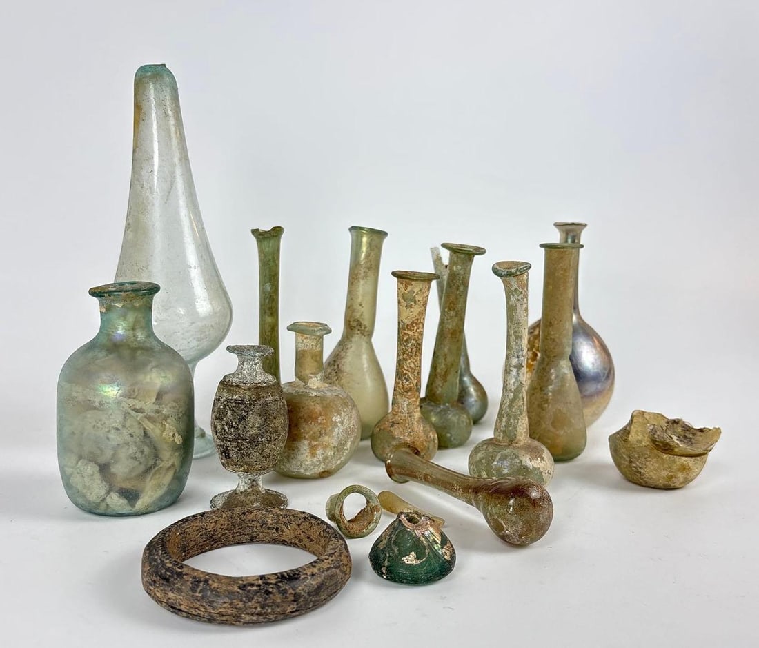 COLLECTION OF ROMAN GLASS UNGUENTARIA AND VESSELS, OBJECTS, FRAGMENTS 1ST/5TH CENTURY (LOT 15): A lot of fifteen ancient glass vessels and objects Dimensions: Tallest 7" Maker: Unknown Provenance: A New York Collector from The Washington University Gallery of Art Notes: Although ca