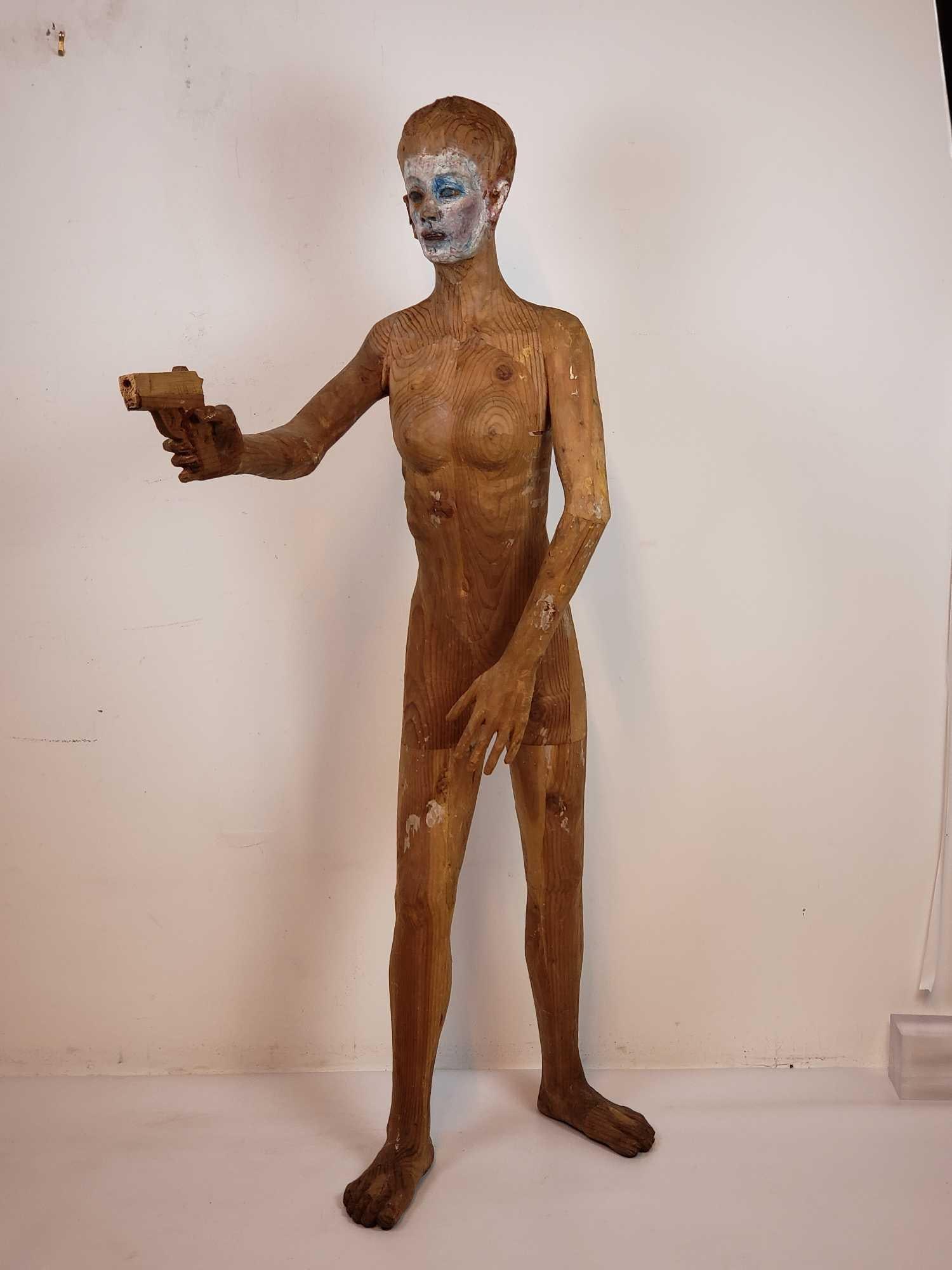 LIFE-SIZED CARVED WOOD GUN WIELDING WOODEN SCULPTURE | OUTSIDER ART | BALKENHOL STYLE: A sculpture reminiscent of the style of Stephan Balkenhol Dimensions of largest: 66"h x 33"w x 19"d Maker: Unknown Provenance: A New York City (Soho) Collector Notes: Although care is tak