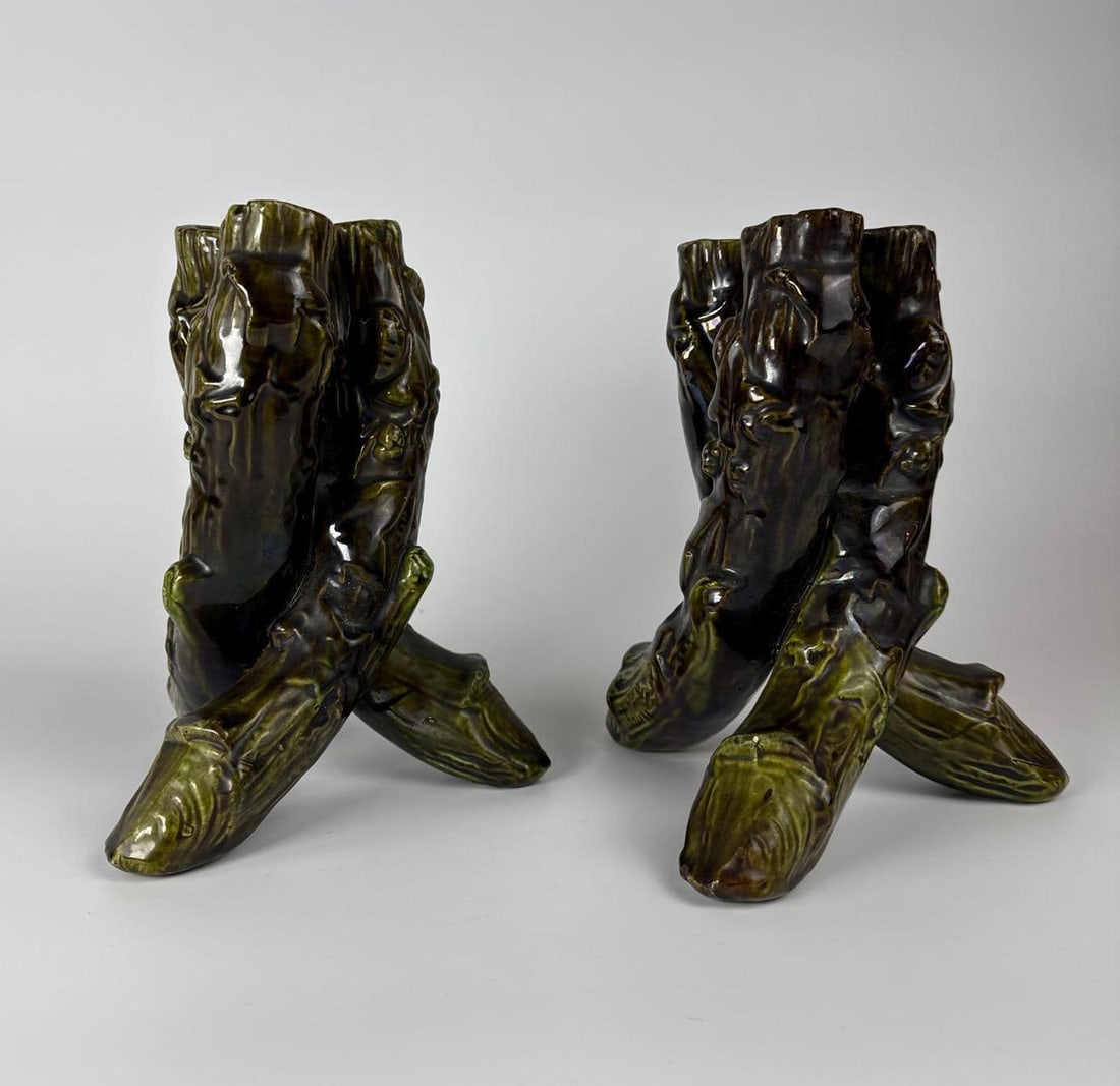 UNUSUAL PAIR OF MAJOLICA VASES/CANDLE STICKS WOVEN TREE FORM: *A pair of green interwoven tree-stem like tubes, with ivy leaf details. Dimensions: 8.5” T Maker: Unknown Provenance: A New York Art Critic's Estate Notes: Although care is taken to ph