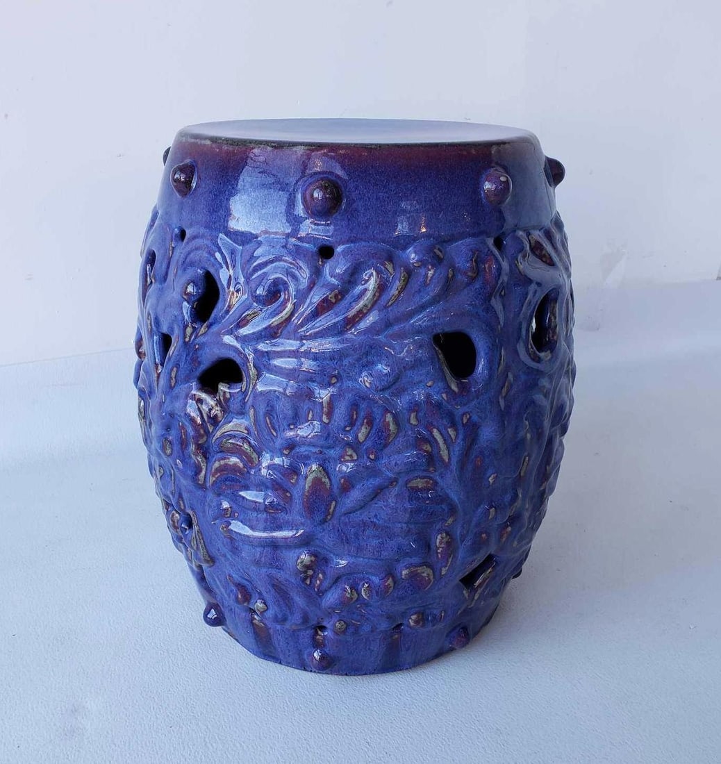 CHINESE GLAZED TERRACOTTA GARDEN SEAT, VIBRANT BLUE TO PURPLE FLAMBÉ GLAZE, LOTUS MOTIF, ANTIQUE: A terracotta garden seat. Dimensions: 17"h x 13.5"dia Maker: Unknown Provenance: A New York Collector Notes: Although care is taken to photograph and describe the item, absence of a conditi
